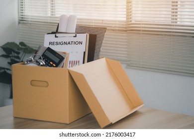 Concept Of Termination Of Employment And Resignation. Quitting A Job, The Big Quit. Resignation.Letter Of Resignation And Cardboard Box On The Desk.