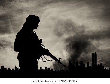 Concept of terrorism. Silhouette terrorist on city background in smoke