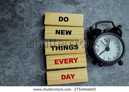 Concept of text do new things every day on wooden blocks.