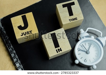 Concept of text JIT - Just In Time on wooden blocks.