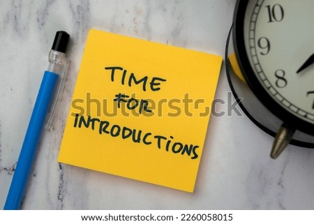Concept of Time for Introductions write on sticky notes isolated on Wooden Table.
