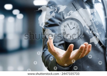 The concept of time management in business process. Businessman holding a wall clock against the background of a world map.