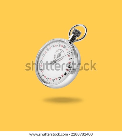 Concept of time. Vintage timer in air on light orange background