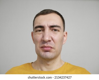 Concept of toothache. Portrait of young caucasian man with swelling cheek with painful expression because of toothache or dental illness on teeth. Man feels strong pain and looks at camera. - Shutterstock ID 2134237427