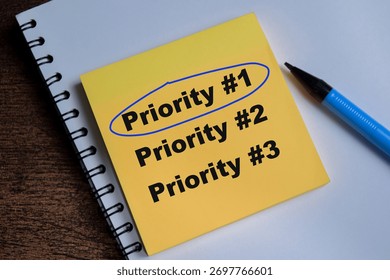 Concept of top priority write on sticky notes isolated on Wooden Table.