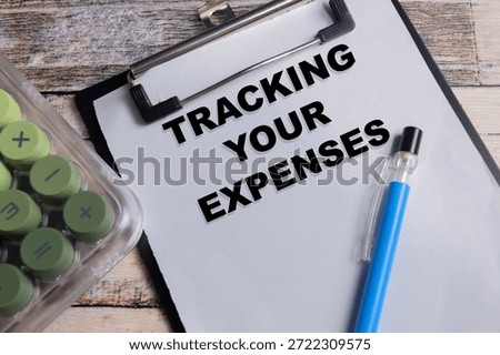 Concept of tracking your expenses write on clipboard isolated on Wooden Table.