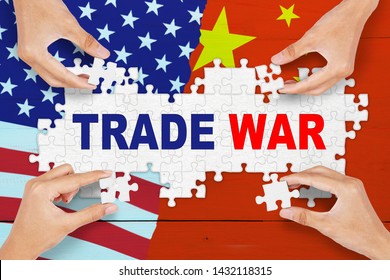 Concept of trade war between USA and China. People hands arrange puzzle pieces with trade war text in background of USA and China flag