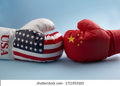 Concept of trade war between USA and China. Two hands of wearing boxing gloves with China and USA flag.