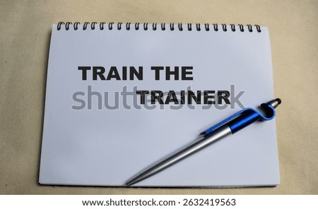 Concept of Train the trainer write on book isolated on Wooden Table.