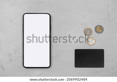 The concept of transferring money to the phone. Payment via smartphone. Phone with connected credit cards or psychic credit card, coins. Electronic money. Process of avoiding physical money Stock photo © 