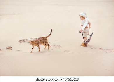 Concept Of Travel And Fascinating Adventures. Hild In Suit Of Treasures Seeker Like Indiana Jones In The Desert Whit Wild Cat Similar To Tiger