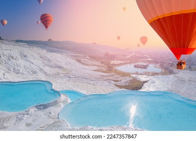 Concept Travel Pamukkale Turkey. Hot air balloon flying Travertine pool and terraces sunset.
