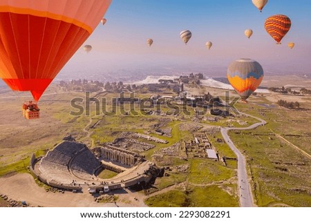Concept Travel Pamukkale Turkey. Hot air balloon flying Travertine pool ancient amphitheater.