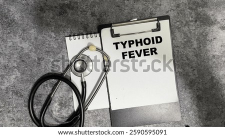Concept of Typhoid Fever write on paperwork isolated on Wooden Table.