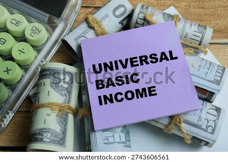 Concept of UBI payment - Universal Basic Income write on sticky notes isolated on Wooden Table. For government financial support, regular cash transfers to citizens