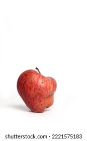 Concept of ugly food - red apple on white background. Image contains copy space