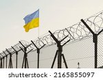 Concept of Ukraine closed borders with flag and wire fence. Ukraine immigration and homeland security. Ukrainian Russian border