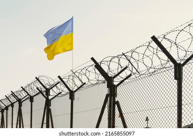 Concept of Ukraine closed borders with flag and wire fence. Ukraine immigration and homeland security. Ukrainian Russian border - Shutterstock ID 2165855097