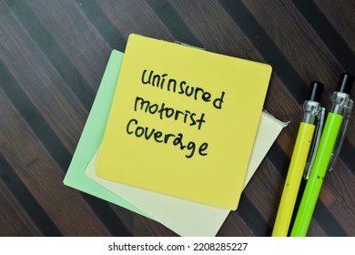 Concept of Uninsured Motorist Coverage write on sticky notes isolated on Wooden Table. - Shutterstock ID 2208285227