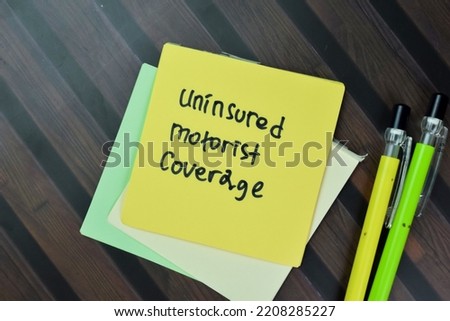 Concept of Uninsured Motorist Coverage write on sticky notes isolated on Wooden Table. Сток-фото © 