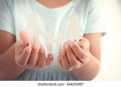 Concept of united family - figures of parents and kids in girls hands - Shutterstock ID 344291087