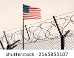 Concept of United States of America closed borders with flag and wire fence. USA immigration and homeland security. American dream concept, not accessible and hard to reach. mexican border