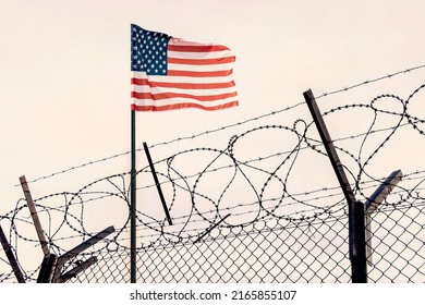 Concept of United States of America closed borders with flag and wire fence. USA immigration and homeland security. American dream concept, not accessible and hard to reach. mexican border - Shutterstock ID 2165855107