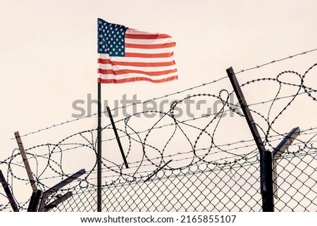 Concept of United States of America closed borders with flag and wire fence. USA immigration and homeland security. American dream concept, not accessible and hard to reach. mexican border