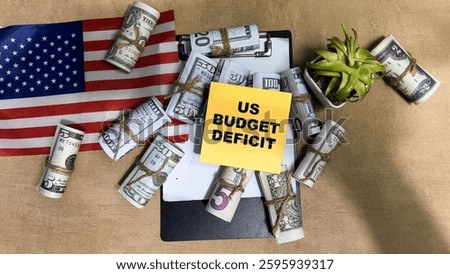 Concept of US Budget Deficit write on sticky notes isolated on Wooden Table.