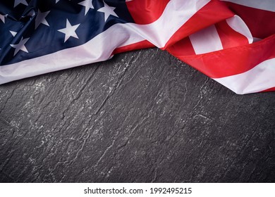 Concept of U.S Independence day or Memorial day. National flag over dark slate table background. - Powered by Shutterstock