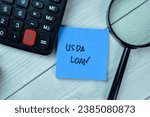 Concept of USDA LOAN write on sticky notes isolated on Wooden Table.