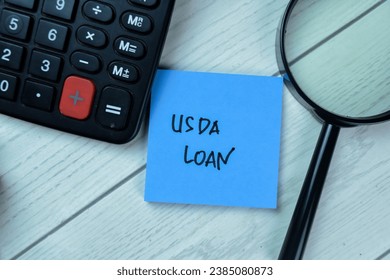 Concept of USDA LOAN write on sticky notes isolated on Wooden Table.