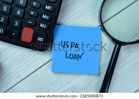 Concept of USDA LOAN write on sticky notes isolated on Wooden Table.