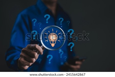 The concept of using creative thinking to help solve problem. Innovation patent, Find solution, think idea, Businessman holding magnifying glass icon with many idea light bulb and question marks.