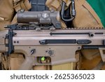 The concept of using modern technologies in the army. Ammunition on a dark background. Weapons and military equipment for army, Assault rifle gun and pistol on camouflage background.