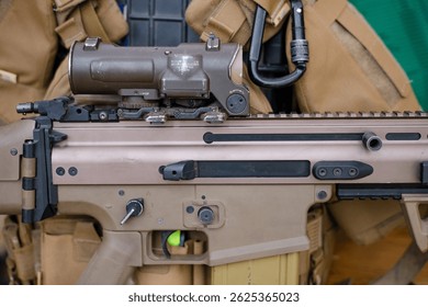 The concept of using modern technologies in the army. Ammunition on a dark background. Weapons and military equipment for army, Assault rifle gun and pistol on camouflage background.