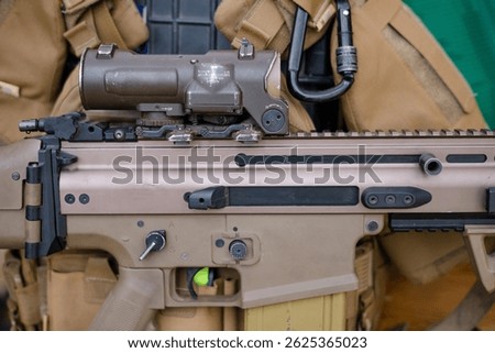 The concept of using modern technologies in the army. Ammunition on a dark background. Weapons and military equipment for army, Assault rifle gun and pistol on camouflage background.