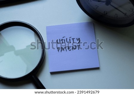 Concept of Utility Patent write on sticky notes isolated on Wooden Table.