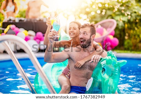 Concept of vacation and leisure time.Couple having fun in swimming pool.