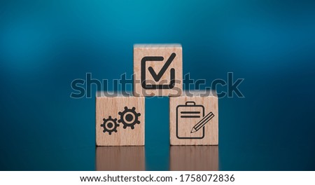 Concept of validation with icons on wooden cubes