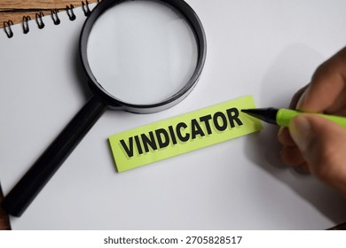 Concept of vindicator write on sticky notes isolated on Wooden Table.