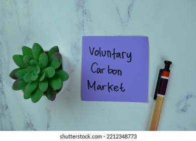 Concept Of Voluntary Carbon Market Write On Sticky Notes Isolated On Wooden Table.