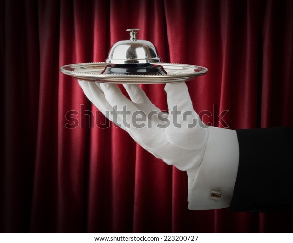 Concept of a\
waiter or butler offering a\
service