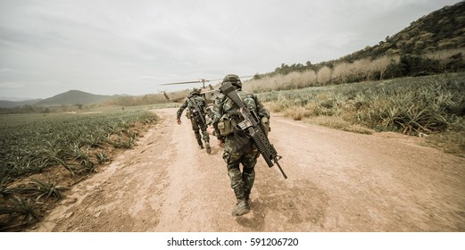 Concept Of War. Silhouette Of A Soldier Carries A Wounded Soldier On A Background Of Sky