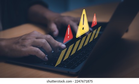 concept, warning or alert software, virus or threat online, scam, user typing on computer keyboard, access caution icon, malicious cyber attack on internet technology.