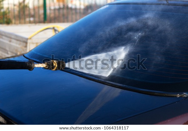 Concept\
Wash the car at home using a professional high-pressure jet spray\
technique. A man washes a foam machine. Car wash. Washing machine\
at the station. Hand-held non-contact car\
wash