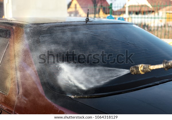 Concept\
Wash the car at home using a professional high-pressure jet spray\
technique. A man washes a foam machine. Car wash. Washing machine\
at the station. Hand-held non-contact car\
wash