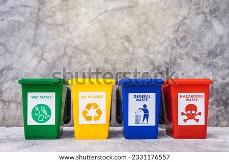 The concept of waste classification for recycling. Collection of bins for different types of garbage by separation according to the color of the bin with old wall background.