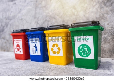 The concept of waste classification for recycling. Collection of bins for different types of garbage by separation according to the color of the bin with old wall background.