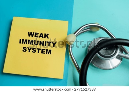 Concept of weak immunity system write on sticky notes isolated on Wooden Table. For healthcare, wellness and diagnostic-related content